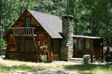 Log cabin in the woods with a stone chimney